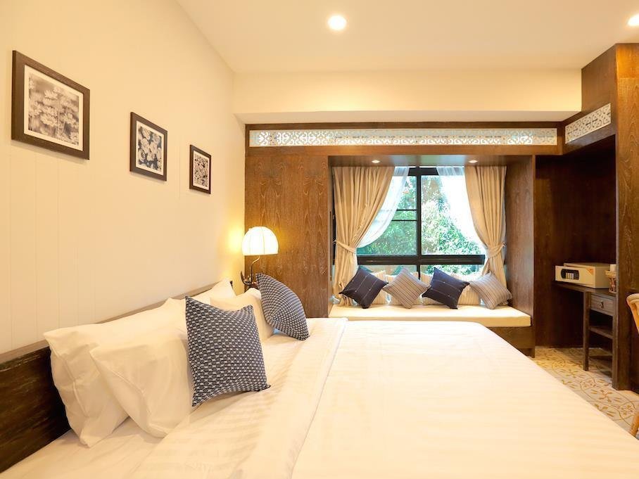 Private bedroom with framed wall art and a curtained window at Amaka Bed and Breakfast