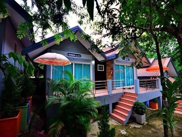 Raised cottages and steps among greenery at Asean Resort Ubon