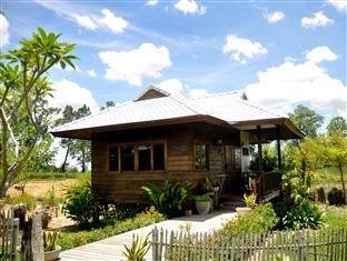 Wooden bungalow beside a garden path at Baan Chai Thung