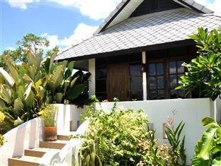 Steps leading to a bungalow terrace among plants at Baan Chai Thung