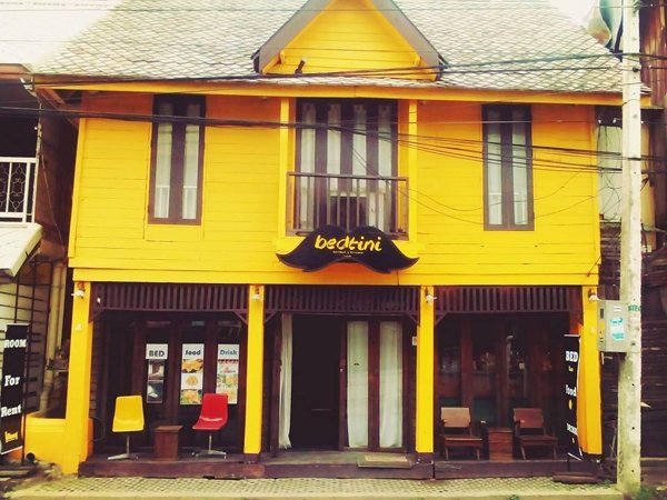 Yellow wooden facade of Bedtini Guesthouse