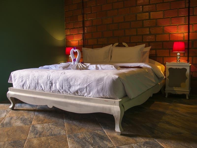 Double bed and brick wall in a Casacool Hotel room