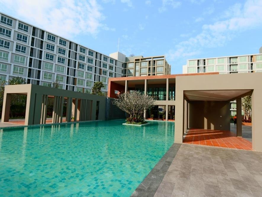Shared swimming pool and condominium buildings at D Condo Sign