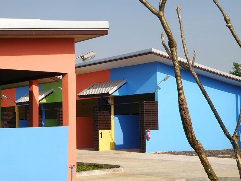 Bright blue and orange single-storey buildings at Tongmai Resort